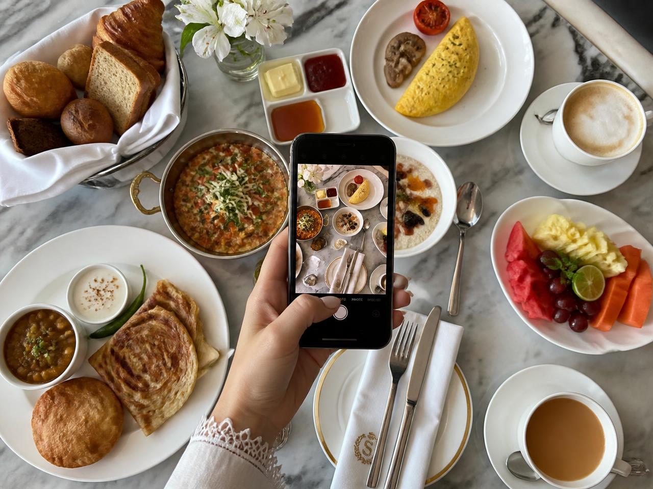 Creator filming a hotel breakfast spread